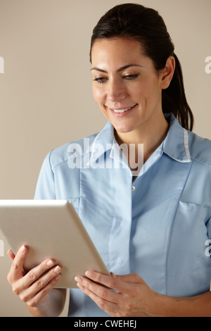 UK nurse using computer tablet Stock Photo