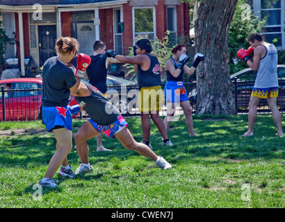 A Group of Young men and women practice outdoors in a city park Muay Thai boxing or Martial Arts in Toronto;Ontario;Canada Stock Photo