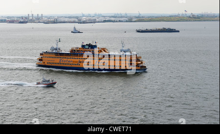 Staten Island Ferry in New York Harbor with armed Coast Guard escort Stock Photo