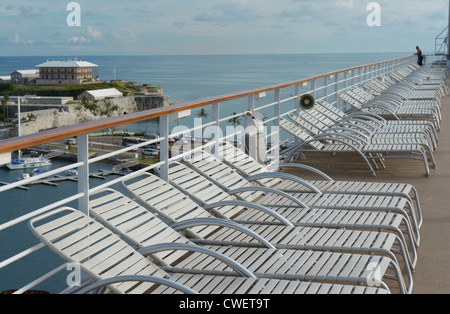 Empty cruise ship deck chairs, King's Wharf Bermuda, The Commissioner's House in view Stock Photo
