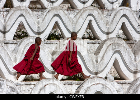 Myanmar, Burma. Mingun, near Mandalay. Two Young Novice Buddhist Monks Walking on the Hsinbyume Paya, a Stupa Built in 1816. Stock Photo