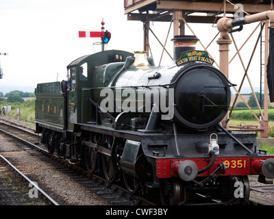 Steam train at water tower at Bishops Lydeard station Stock Photo