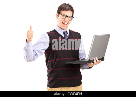 Happy young man with laptop showing thumb up isolated on white background Stock Photo