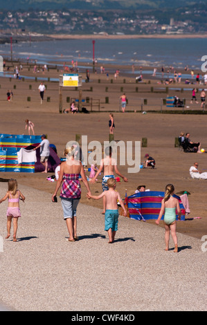 Family Day Out At The Beach (selective focus on the family walking) Stock Photo