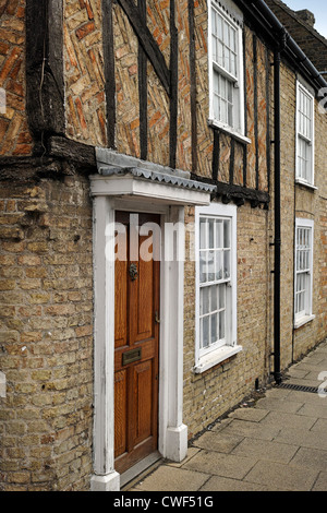 Old terraced house built of brick with timber frame in Waterside Ely Stock Photo