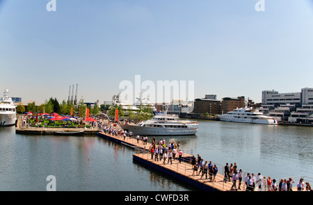 Luxury Yachts at anchor in West India Docks,Olympic 2012 entertainment,Office Construction,Canary Wharf Buildings,London,UK Stock Photo