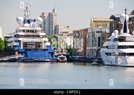 Luxury Yachts at anchor in West India Docks,Octopus belonging to Microsoft Billionaire,Canary Wharf Buildings,London,UK Stock Photo