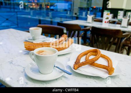Breakfast: coffee with churros and porras. Madrid, Spain. Stock Photo