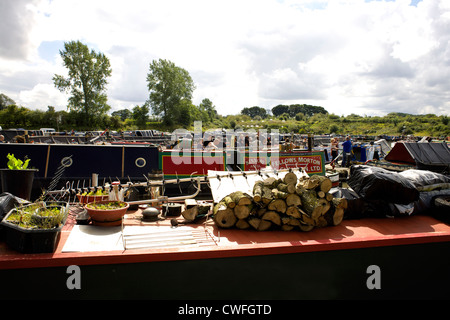 Logs on the roof of a narrowboat, Alvecote Marina, Coventry Canal, near Tamworth, Staffordshire, England, UK, during the 2012 Stock Photo