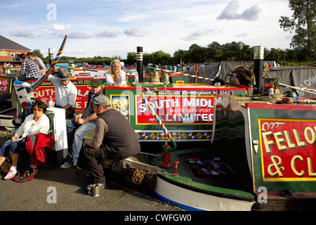 Boaters in traditional costume with their colourful historic narrowboats, Alvecote Marina, Coventry Canal, near Tamworth, Stock Photo