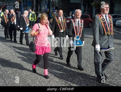 Woman in pink among members of the Orange Order, Donegall Square South, Belfast. Stock Photo