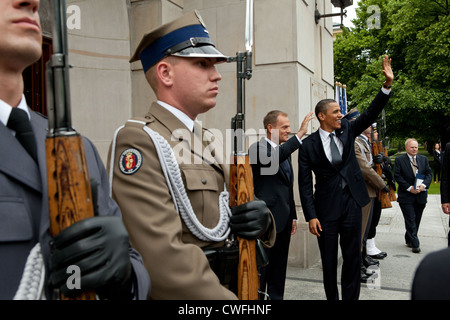 President Barack Obama and Prime Minister Donald Tusk of Poland wave to onlookers upon President Obama's arrival to the Chancell Stock Photo