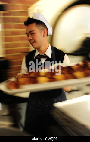 USA California CA San Francisco Ghiradelli Square - chocolate manufacturers - man making chocolate dipped waffle cones Stock Photo