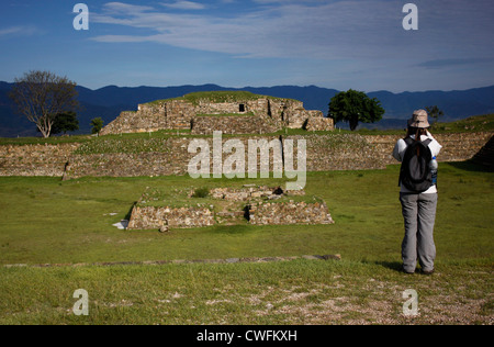 A tourist takes pictures in the Zapotec city of Monte Alban, Oaxaca, Mexico, July 13, 2012. Stock Photo