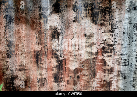 Close surface detail of corrugated sheeting with paintwork decaying. Weathered paint texture, old paint texture, rough texture faded by time. Stock Photo