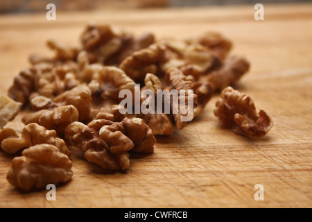 Walnuts on wooden chopping board close-up Stock Photo
