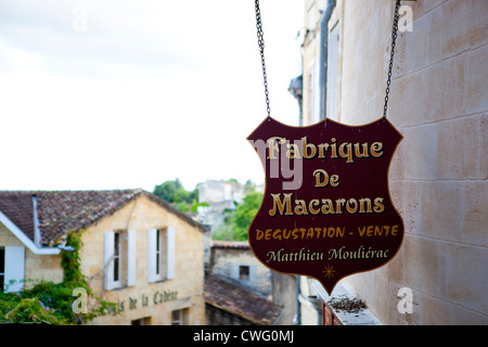 A macaroon shop sign down a narrow street in Saint Emilion, Southern France Stock Photo