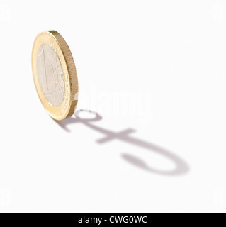 close-up of euro coin, casting the shadow of a pound sign Stock Photo