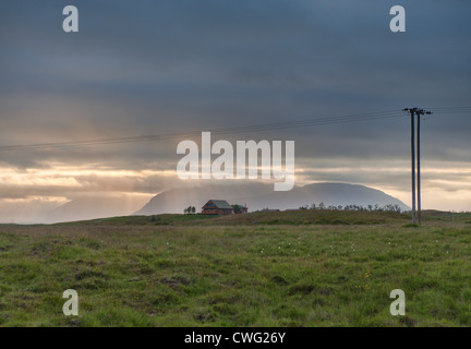 Rays of sunlight fall over a house in south Iceland during long summer evening Stock Photo