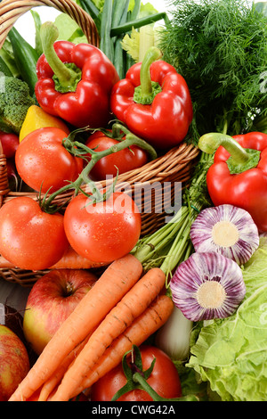 Composition with raw vegetables and wicker basket Stock Photo