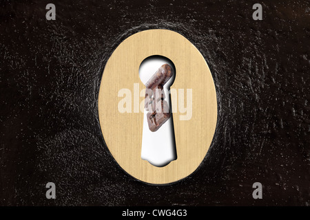 A key about to be placed into a rim lock Stock Photo