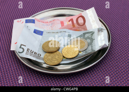 Euro tips and payment for bill on on restaurant table. Stock Photo