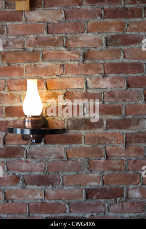 Old-fashioned sconce light on a brick wall. Stock Photo