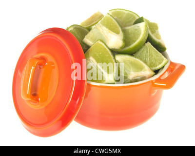 Colourful Orange Pot, Filled With Freshly Cut Ripe Green Limes Isolated Against White Background, With Clipping Path And No People Stock Photo