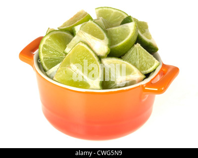 Colourful Orange Pot, Filled With Freshly Cut Ripe Green Limes Isolated Against White Background, With Clipping Path And No People Stock Photo