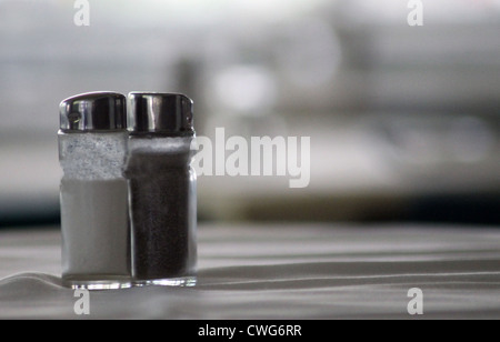 Salt and pepper shakers on table with copy space, food and drink concept. Stock Photo