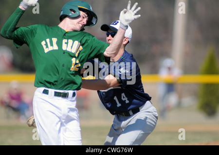 Baseball First baseman tags a hitter before he can reach first base during a high school game. Stock Photo