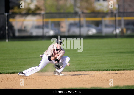 Baseball Infielder in position to field a ground ball high school game. USA. Stock Photo