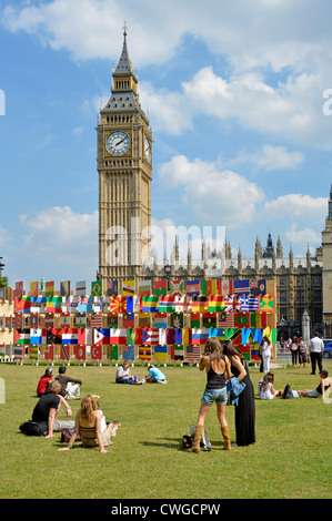 Some of the Olympic nations flags that are competing in London 2012 mounted on wooden panels with Big Ben & Parliament beyond Stock Photo