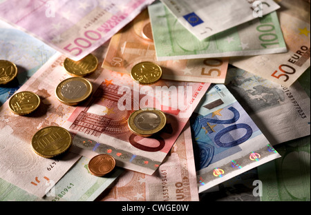 Euromuenzen on disarranged euro notes in various denominations Stock Photo