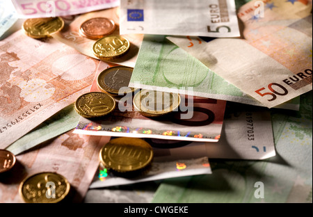 Euromuenzen on disarranged euro notes in various denominations Stock Photo