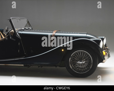 Bonnet of a Green Morgan Roadster 4/4 car with brown leather strap Stock Photo