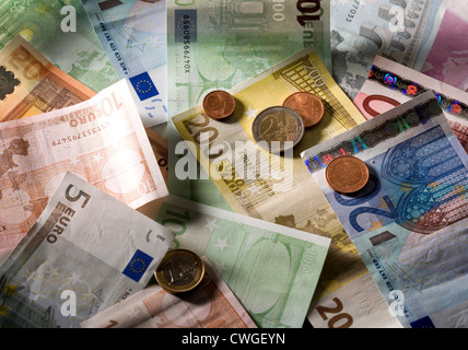 Euromuenzen on disarranged euro notes in various denominations Stock Photo