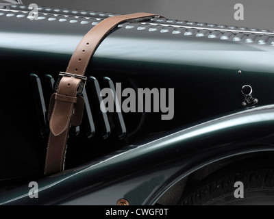 Bonnet of a Green Morgan Roadster 4/4 car with brown leather strap Stock Photo