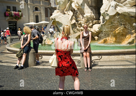 Rome, Italy - August 2012 - Two young female tourists taking photos in Piazza Navona Stock Photo