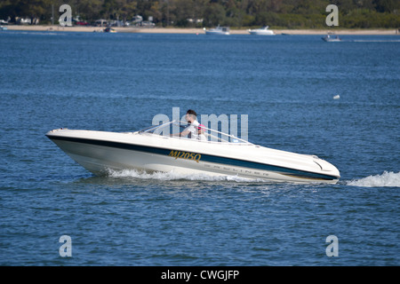 Middle aged couple in speedboat Stock Photo