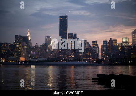Mid Town of New York City seen from Long Island City at night Stock Photo