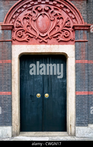 Black, heavy door of an old residential structure in Shanghai, China Stock Photo