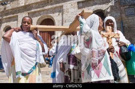 Ethiopian Christian pilgrims carry across along the Via Dolorosa in Jerusalem , Israel Stock Photo