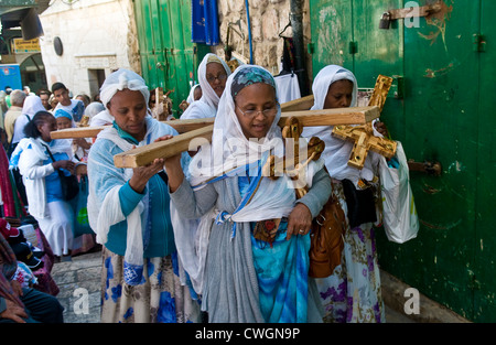 Ethiopian Christian pilgrims carry across along the Via Dolorosa in Jerusalem , Israel Stock Photo