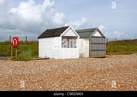 WOODEN BEACH HUTS ON A SHINGLE BEACH. NORMANS BAY EAST SUSSEX UK. Stock Photo