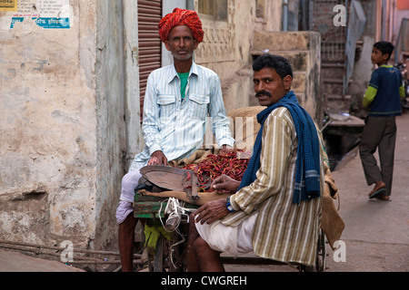 Men selling red peppers on street in Bundi, Rajasthan, India Stock Photo