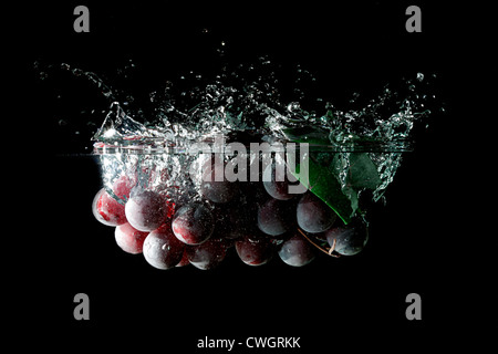 Splashing grapes on a black background Stock Photo