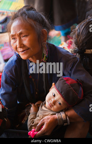 A ANN TRIBAL woman with her GRANDSON in traditional dress in her village near KENGTUNG also known as KYAINGTONG - MYANMAR Stock Photo