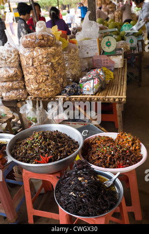 Vertical close up of weird deep fried insects, locusts, frogs and spiders on sale at a market stall in Cambodia Stock Photo