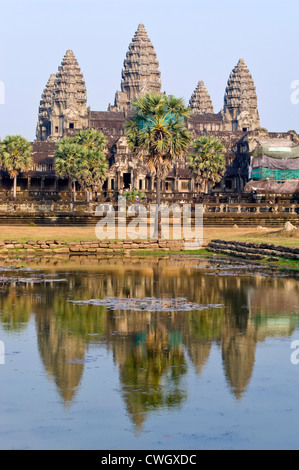 Vertical view over the lake of the amazing iconic architecture at Prasat Angkor Wat on a sunny day. Stock Photo